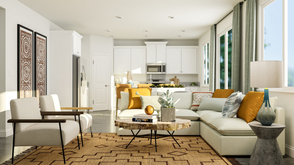 Staged rendering of great room with view into the kitchen, furnished with beige sofa, two armchairs, and coffee table.