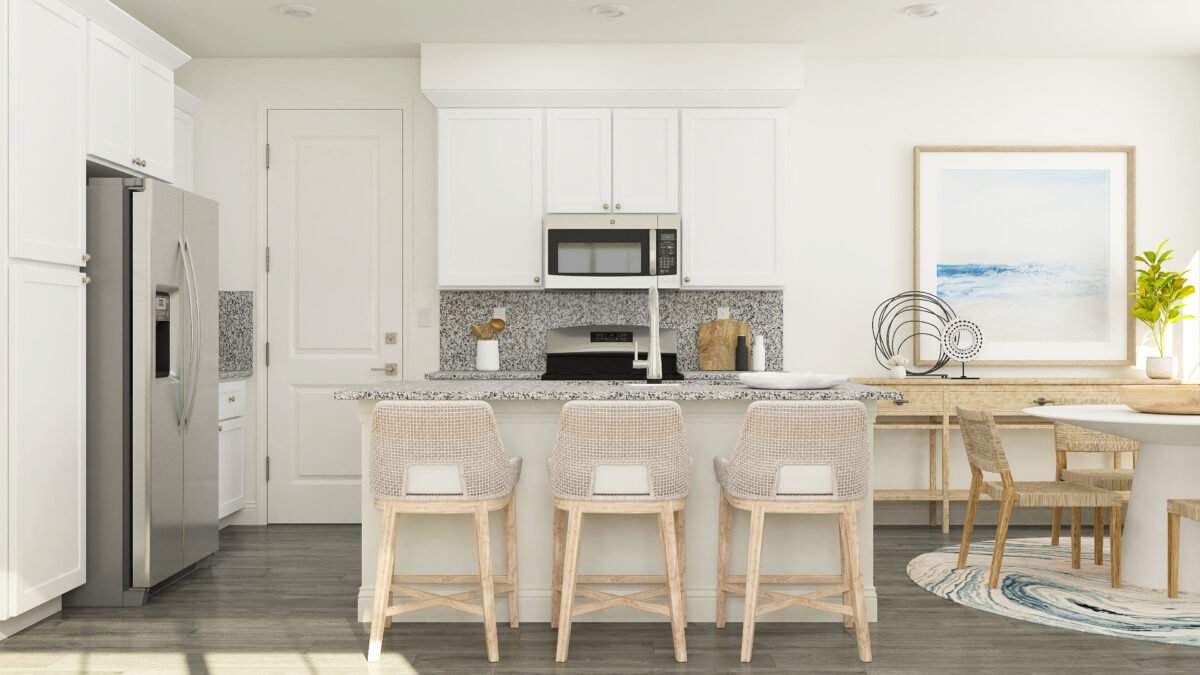 View of kitchen and partial dining area with focus on kitchen island and stools.