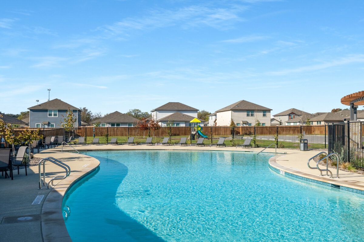 Abbott Place community pool with view of homes in the distance.