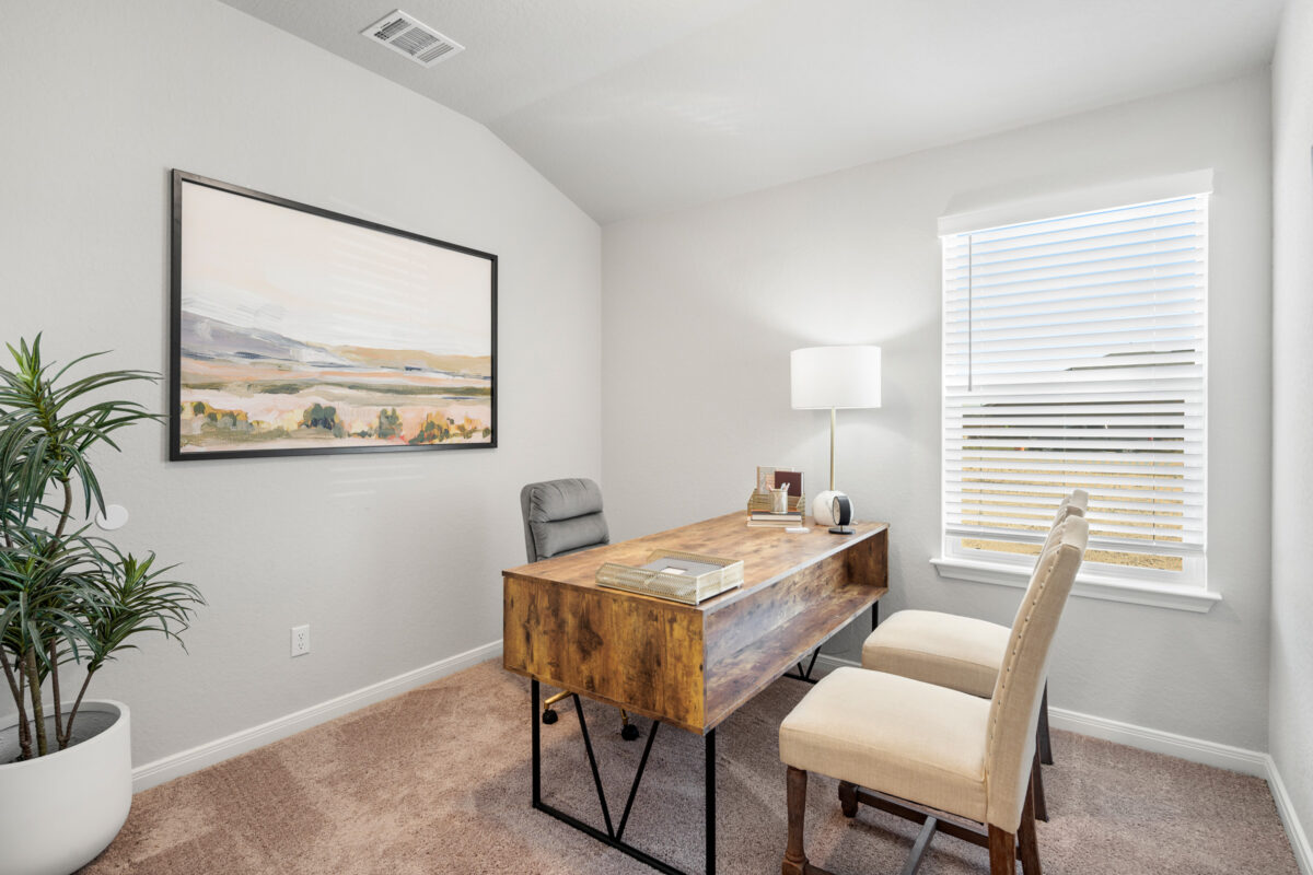 Photo of office furnished with desk and two chairs.