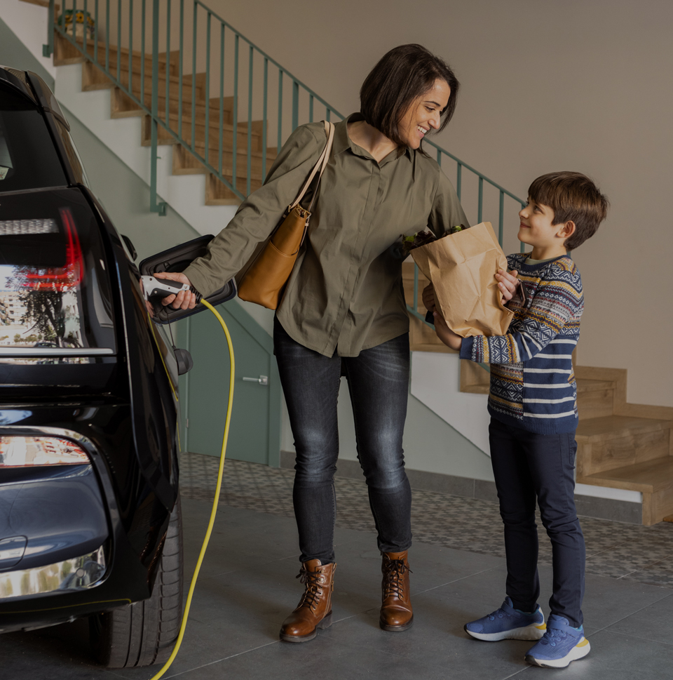 image of a mother and son charging an electric vehicle