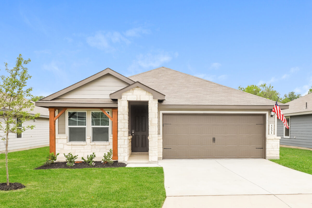 Front view of beige house with dark brown trim