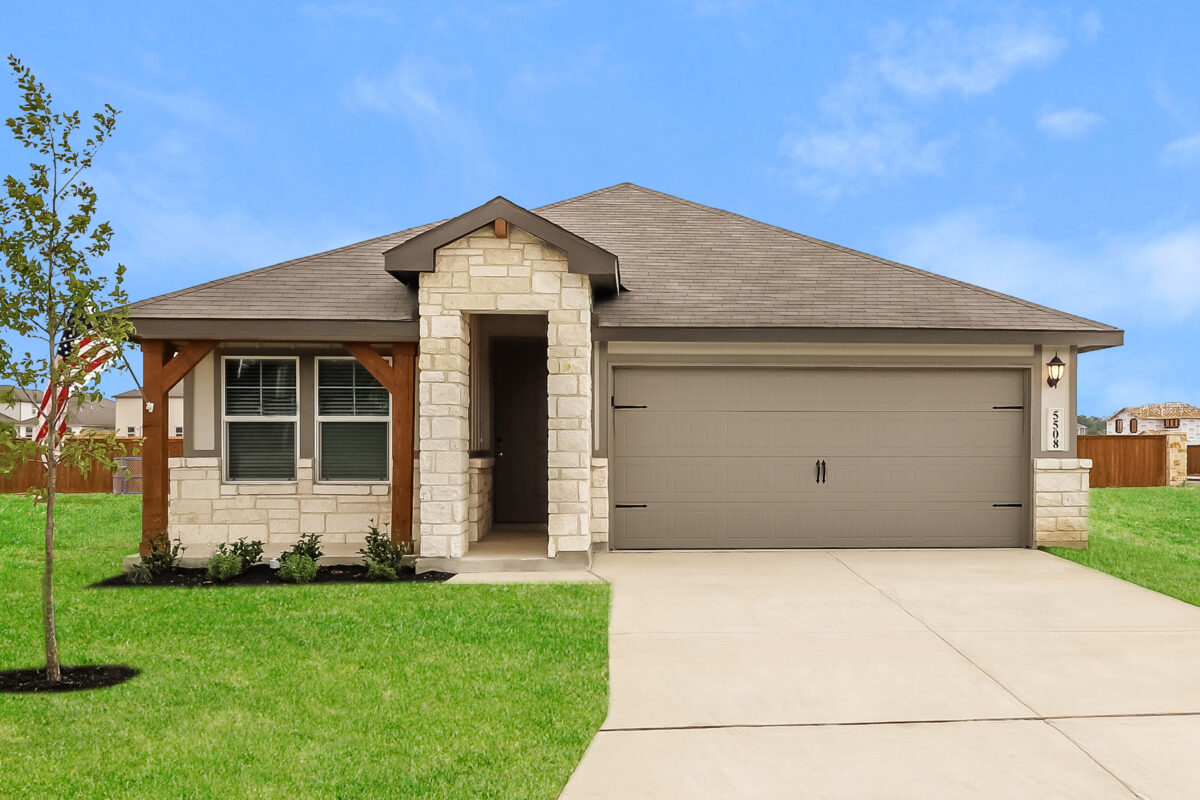 Front view of of beige house with dark brown trim