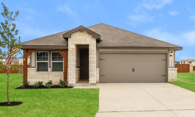 Front view of of beige house with dark brown trim