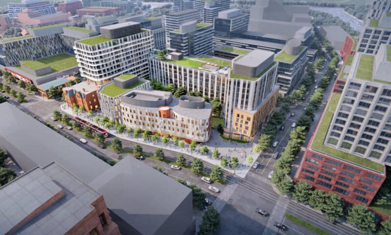 Rendering of city hub with multi use buildings, roads, cars and greenspace.