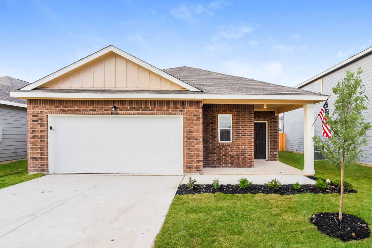 Front view of brick house with beige trim