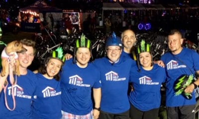 A group of people with matching t-shirts at a night time ride.
