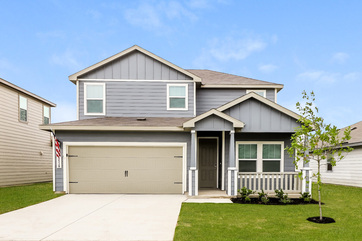 Front view of two story grey house with white trim