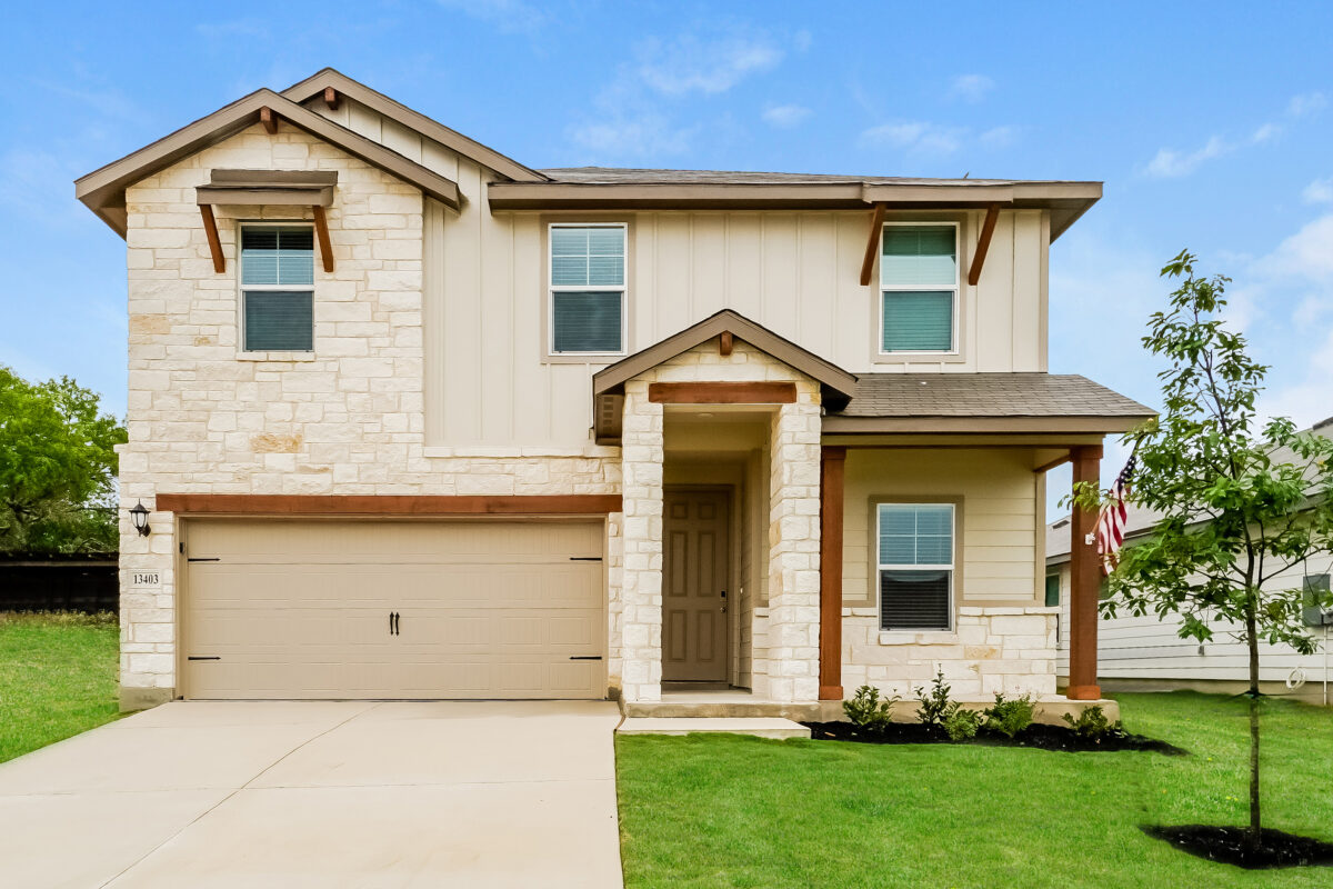 Front view of beige house with dark brown trim