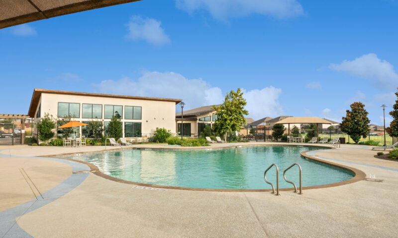 Outdoor view of resort style pool with sundeck.