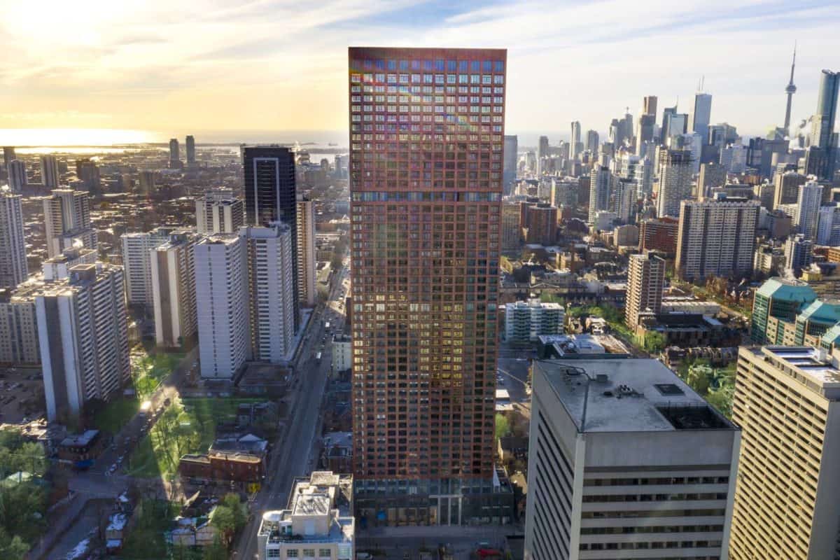 Aerial view of a city skyline with a closeup of a high rise building.