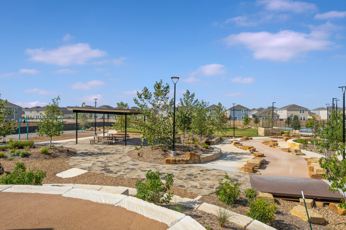 View of common areas and walking paths with shaded seating area nearby.