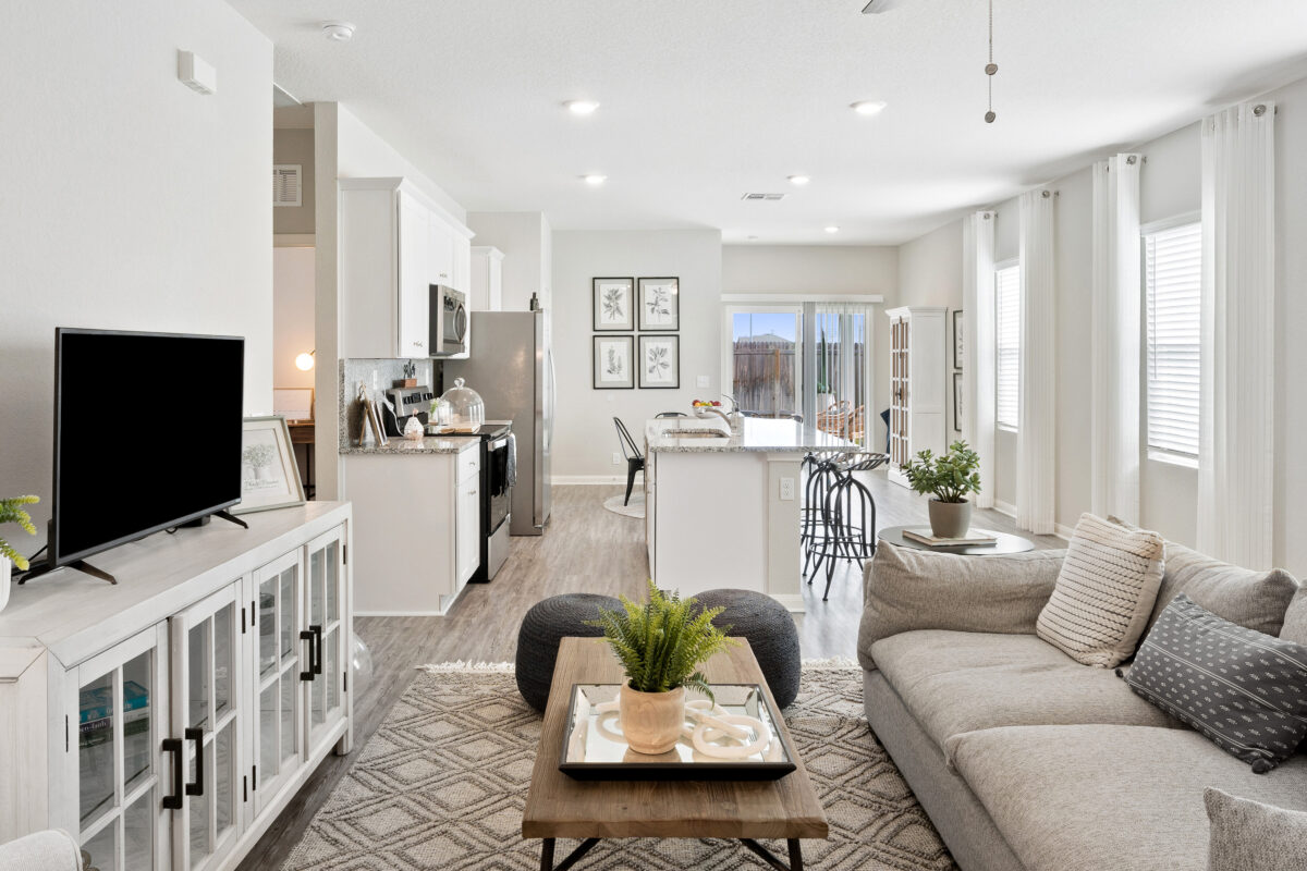 View of staged living area and kitchen.