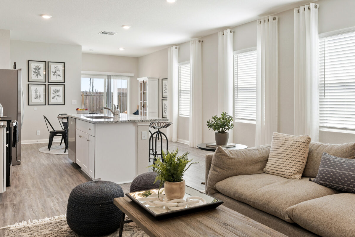 View of staged living room and kitchen in Trails at Culebra model home.