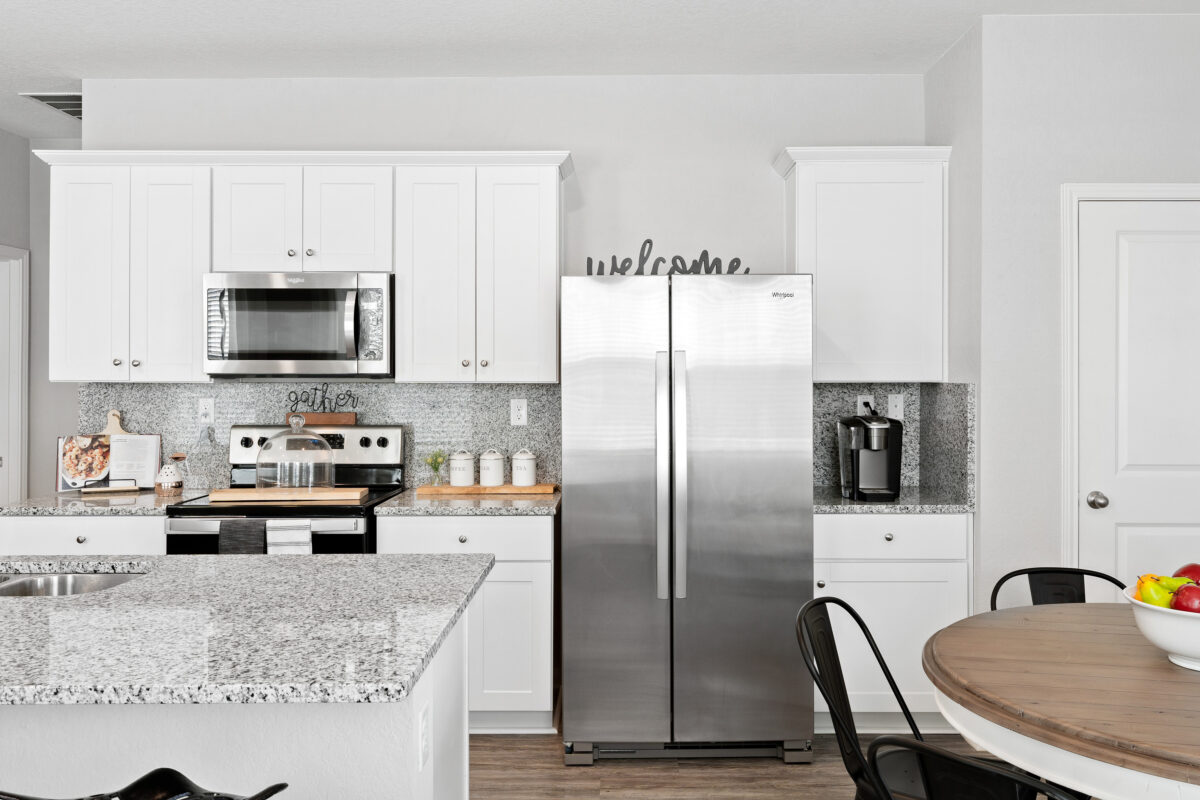 View of granite countertops and stainless steel kitchen appliances in Trails at Culebra model home.