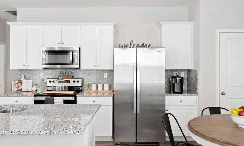 View of granite countertops and stainless steel kitchen appliances in Trails at Culebra model home.