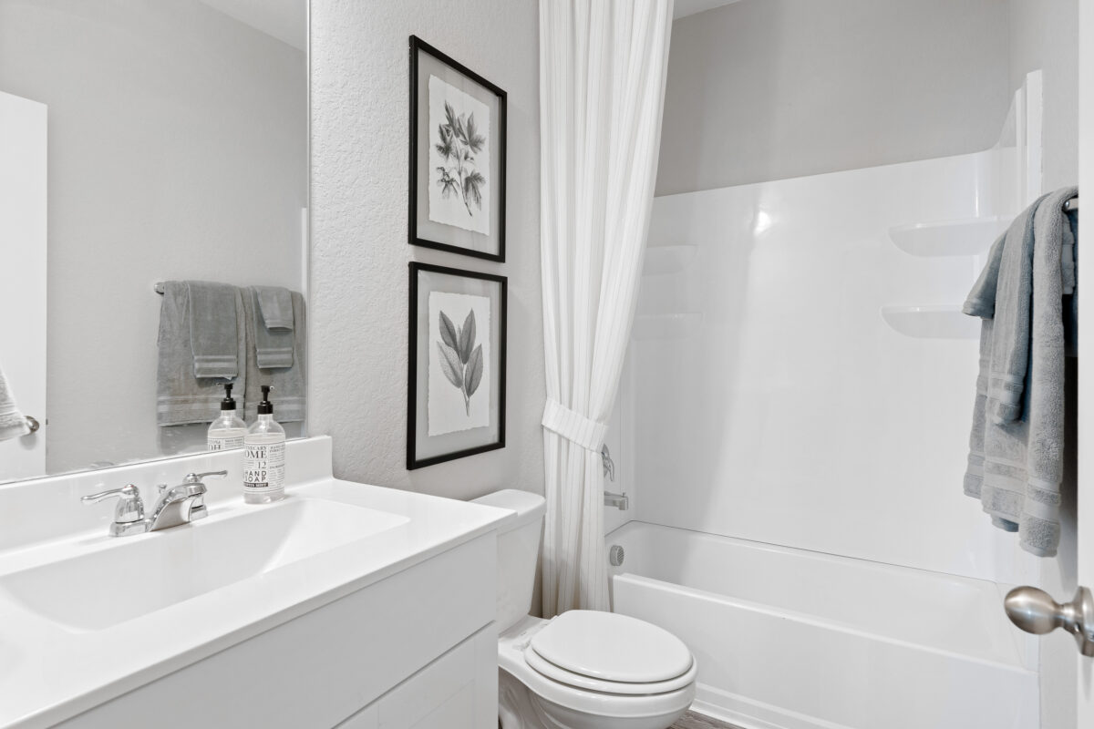 View of staged bathroom with shower and tub.