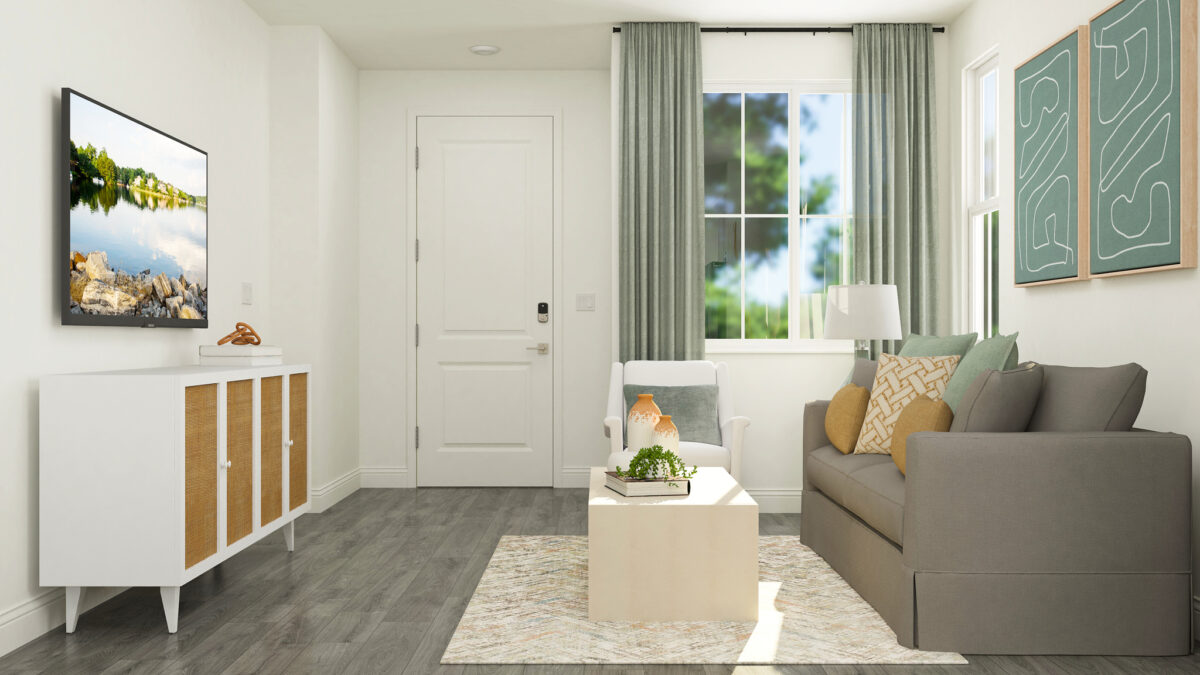 Staged rendering of great room and entryway furnished with tan sofa, armchair, coffee table and a window in the background.