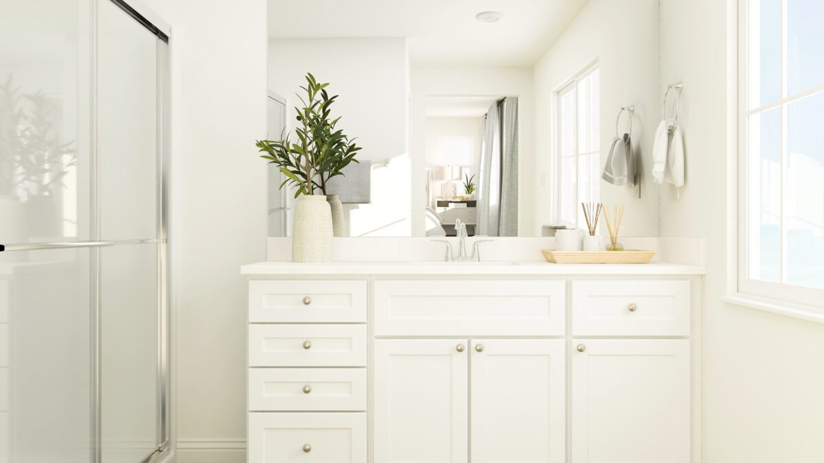 Primary bathroom showing countertop, sink and walk-in shower with partial view of window on the left.