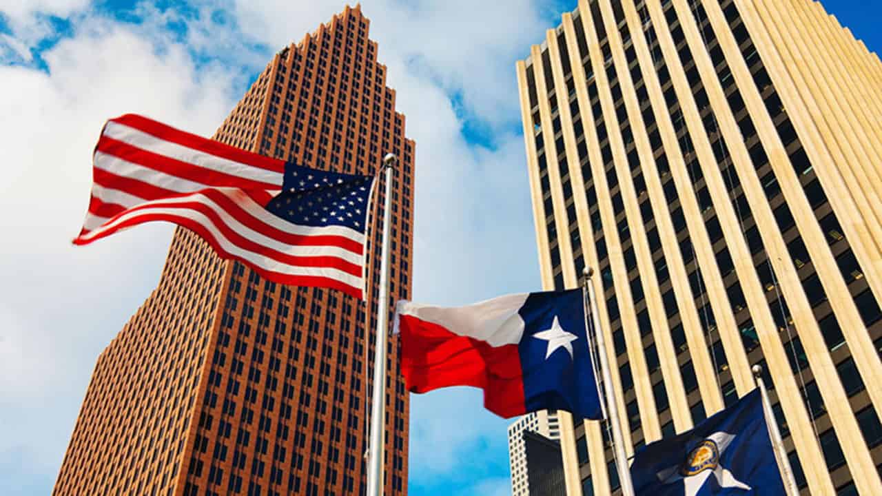 View of downtown skyscrapers and flags, including the American, Texas, and Houston flag..