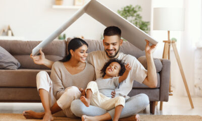 Happy multiethnic family under roof stock photo