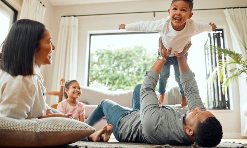 Shot of a young family playing together on the lounge floor at home