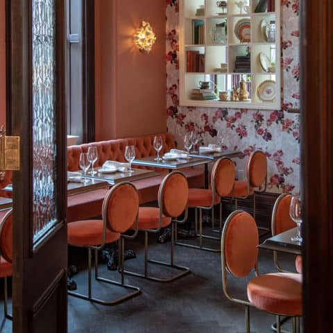 French inspired restaurant setting dining room setting with tables and chairs.