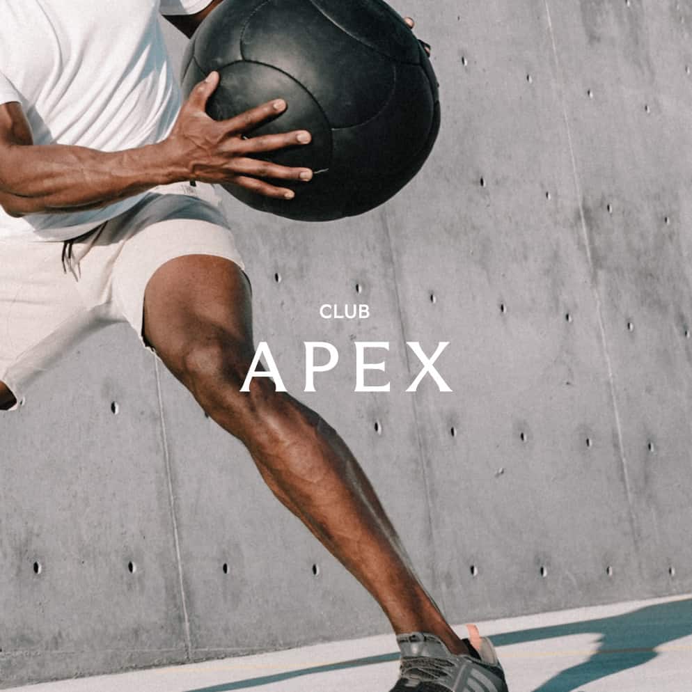 Shot of a man's leg and arm holding black medicine ball.