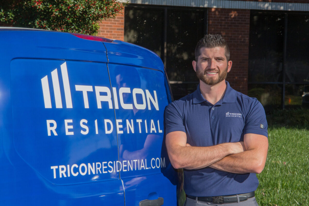 Image of Tricon maintenance technician positioned next to a vehicle